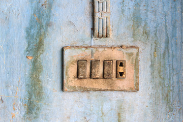 Old electric outlet in an old house interior on wall concrete