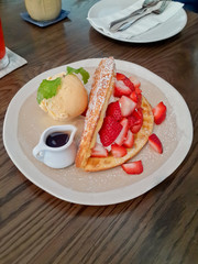 Strawberry Waffle, Fresh cream strawberry and House made vanilla Ice cream on the wood table
