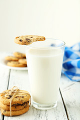 Glass of milk on white wooden background
