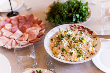 Fresh salad with corn and crab meat with mayonnaise on a festive table
