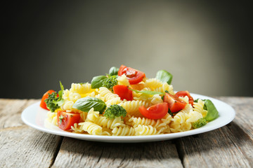 Delicious pasta on plate on grey wooden background