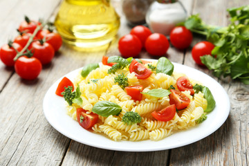 Delicious pasta on plate on grey wooden background
