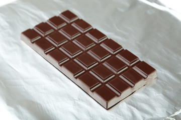 Dark chocolate bar on foil