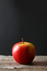 Red apples on grey wooden background