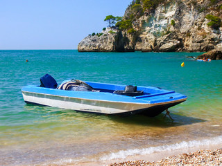 Small boat moored in a small bay (Gargano, Italy)