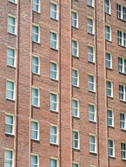 Fototapeta na wymiar Windows on Red Brick Apartment Building