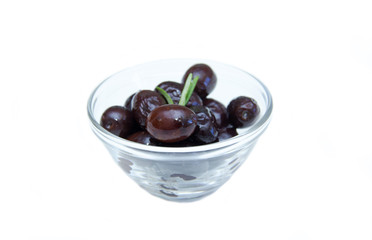 Black olives on bowl on white background