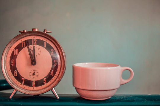 Old clock and coffee cup