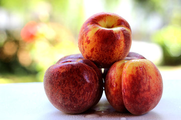 Washed Peaches on the table in the courtyard