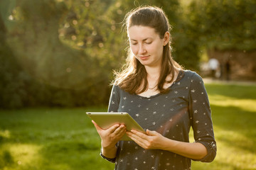 Young woman using tablet outdoor