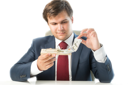 portrait of businessman holding mousetrap and putting money in i
