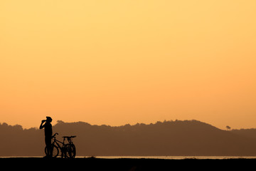 Fototapeta na wymiar Cyclist rides at sunset.