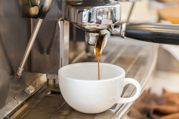 Fototapeta na wymiar Prepares espresso in coffee shop