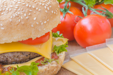 Tasty cheeseburger with lettuce, beef, double cheese and ketchup. Macro with shallow focus.