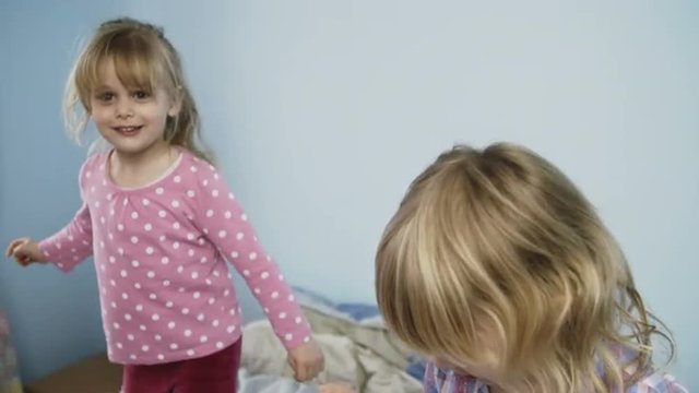 Little kids jumping on bed. Shoot on Digital Cinema Camera in slow motion - ProRes 422 codec.