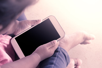 kid's hands hold smart phone,tablet,cellphone for playing