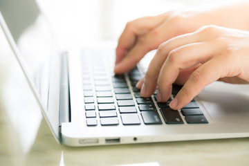 Closeup of business woman hand typing on laptop keyboard ( Filte