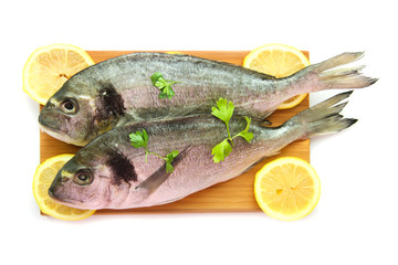 Two dorado on wooden board