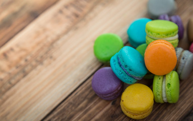 Fototapeta na wymiar French colorful macarons on wood table