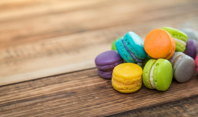 French colorful macarons on wood table