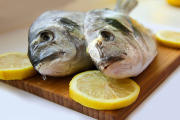 Two dorado on wooden board