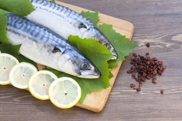Fresh mackerel in grape leaves with lemon slices
