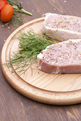 Fresh Raw Steak Meat with spaces, herbs and vegetables, selective focus