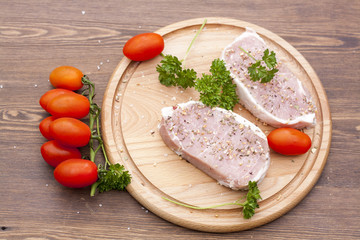 Fresh Raw Steak Meat with spaces, herbs and vegetables, selective focus
