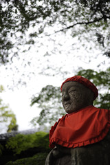 Stone statue and green leaves, Iwate Prefecture, Japan