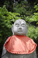 Stone statue and green leaves, Iwate Prefecture, Japan