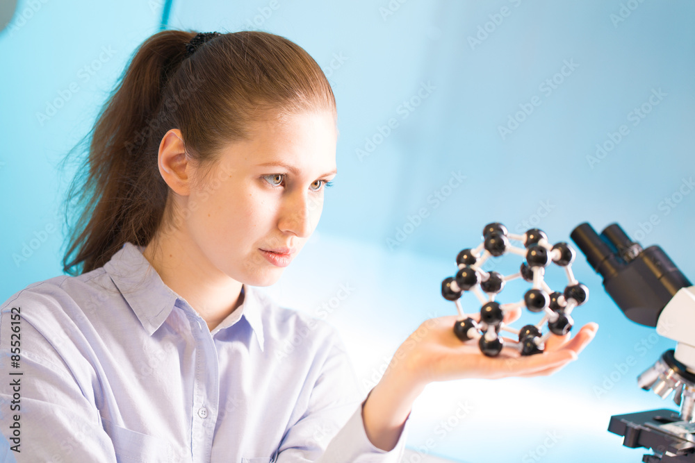 Poster young woman scientist working at the laboratory. Model of molecu