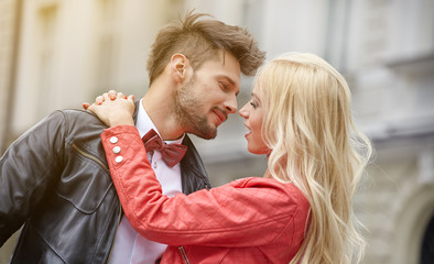 Fototapeta premium young couple kissing in the street of the old city