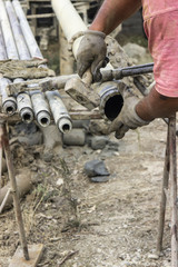 Worker hands installing drilling bit