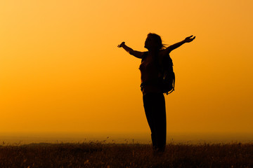 Fototapeta na wymiar Woman hiker greeting the sunset