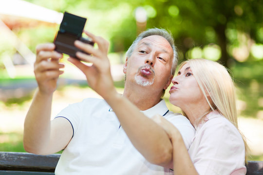 Adult couple taking a selfie at the park