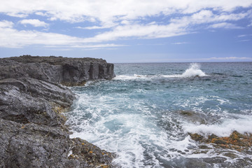 Fototapeta na wymiar Rocks with Waves on Kauai North Coast