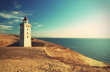 Lighthouse Rubjerg Knude and sand dunes at the danish North Sea coast, vintage style, Denmark,...