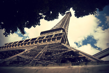 look up to the Eiffel Tower, the most recognizable landmark of Paris, France, Europe, Vintage filtered style