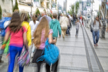 Blurred pedestrian in the city, zoom effect, motion blur