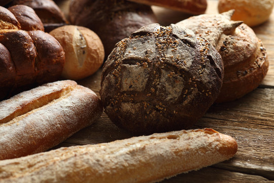 Assortment of fresh bread on a wooden background