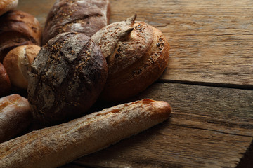 Assortment of fresh bread on a wooden background