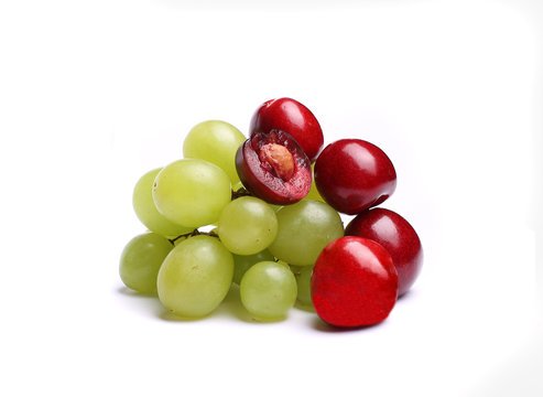 cherry, bunch of grapes on white background