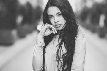 Hispanic young woman wearing casual clothes in urban background