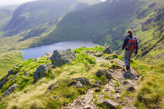 A Lone Hiker Walking In The Lake District