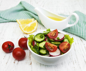 Spring salad with tomato, cucumbers and radish