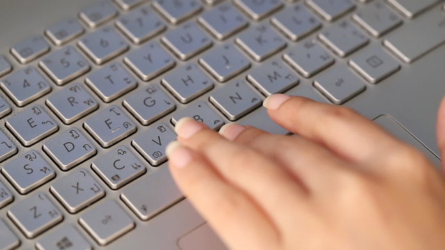 hand pressing The Space Bar button in laptop keyboard