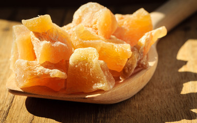 Closeup candied ginger on wooden spoon
