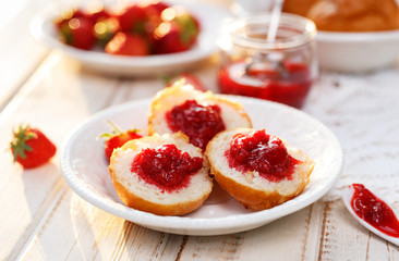 Homemade strawberry jam on a buttery scones