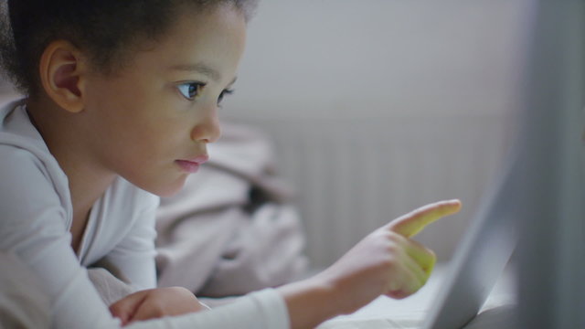 Young girl playing on a digital tablet device