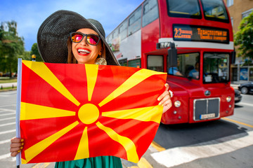 Woman with macedonian flag in Skopje city